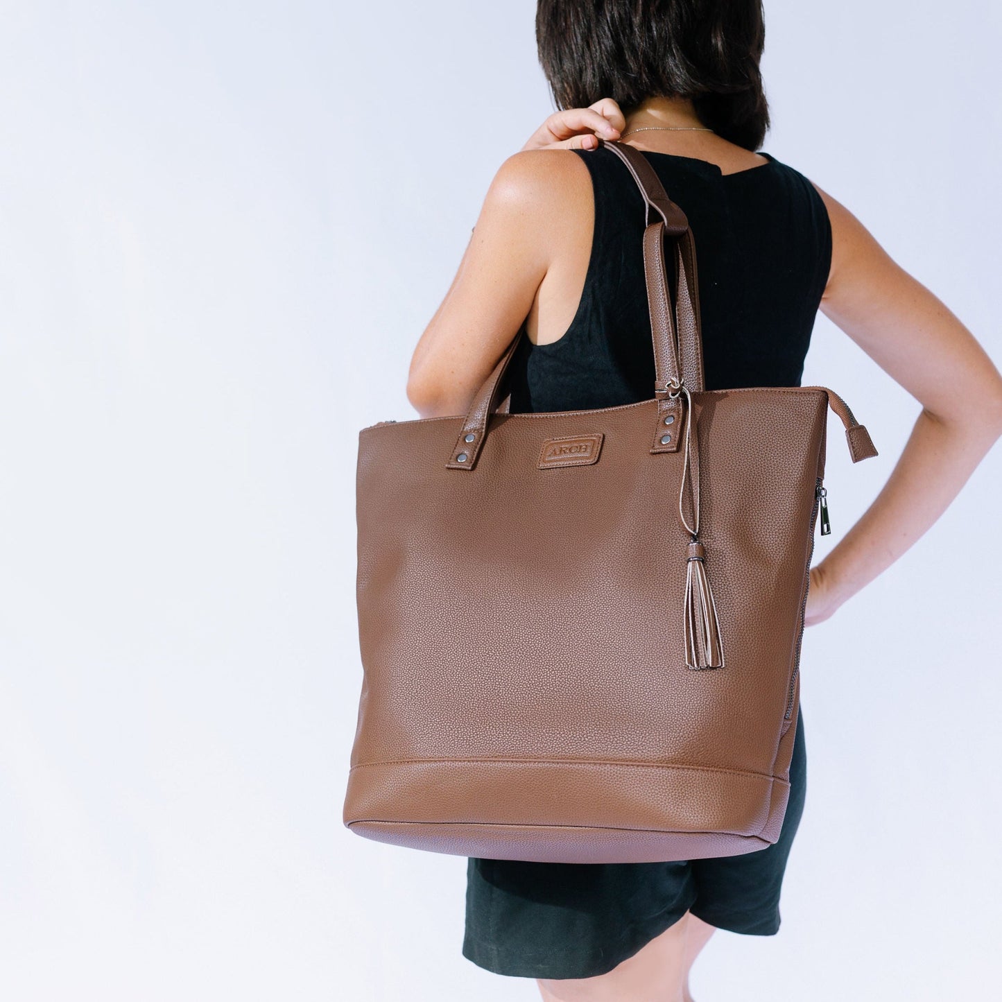 Brown Arch nappy bag worn as a shoulder bag